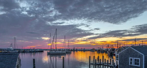 A panoramic shot of sailboats in harbor at scenic sunset in Martha's Vineyard, Massachusetts, USA