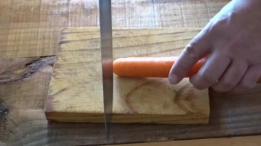 Tahta bir tahtanın üzerinde kesilmiş bir havucun yakın plan çekimi.