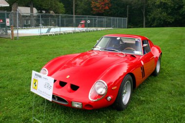A closeup of a red 1962 Ferrari 250 GTO displayed at the FCA NER Stamford Concour in Connecticut, USA clipart