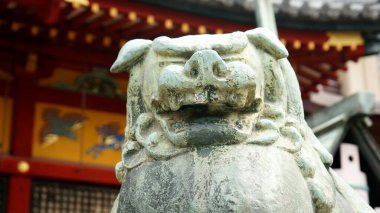 Geleneksel bir binanın arka planında Japon ejderhasının heykelinin yakın plan fotoğrafı..