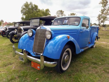 Old blue Mercedes Benz 170 w136 pickup truck circa 1950. Green grass nature background. Utility or farming tool. Classic car show.