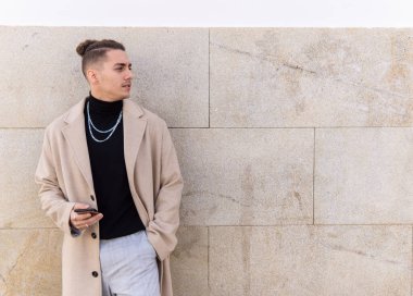 Şehirde akıllı telefon tutan melez bir gencin portresi. Sosyal medya, iletişim, mobil uygulamalar, iş, yaşam tarzı kavramı