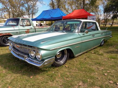 Chascomus, Arjantin - 9 Nisan 2022 - Eski gri Chevrolet Chevy Bel Air sedan dört kapı 1961 klasik tur arabası çimlerin üzerinde park edilmiş. Kopyalama alanı