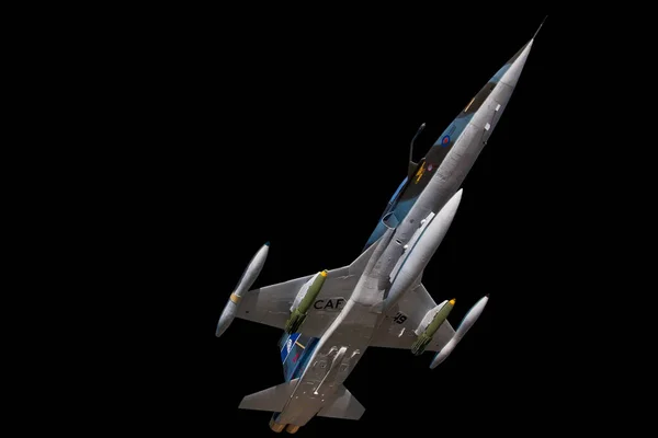 A CF5 military aircraft -jet fighter of the Canadian Armed Forces on a black background