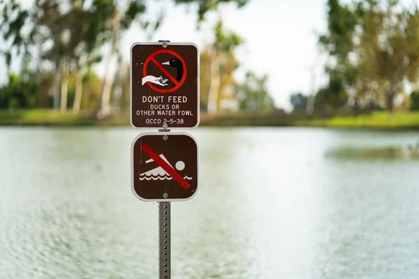カリフォルニア州トライシティ パークにあるアヒルやその他の水鳥に餌を与えないための標識 — ストック写真
