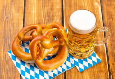 Alman Ekim Festivali için kahverengi bir masada yakın plan simit ve bira.