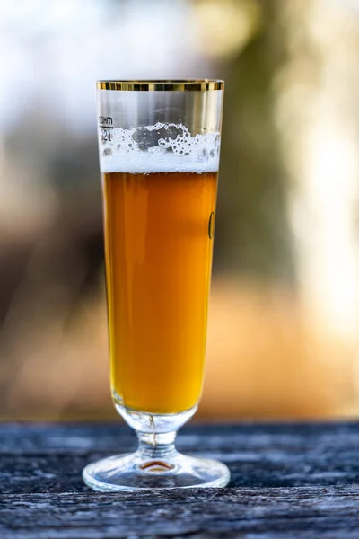 背景がぼやけている木製の表面にビールのガラスの垂直閉鎖 — ストック写真