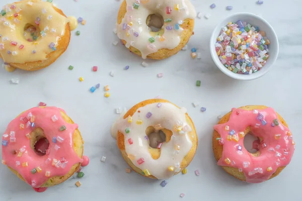 Top View Tasty Creamy Doughnuts Covered Colorful Sprinkles Marble Surface — Stock Photo, Image