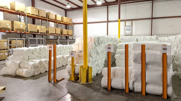 Fiberglass shipped from China waits for use in warehouse.