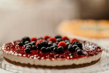 Meyvelerle süslenmiş lezzetli kekin seçici odak noktası.