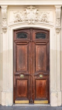 Paris, ancient wooden door, typical building in the 10e arrondissement, rue de Marseille