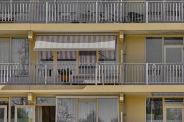 Sarı bir binanın retro tarzı balkonu. Arka planlar için harika.