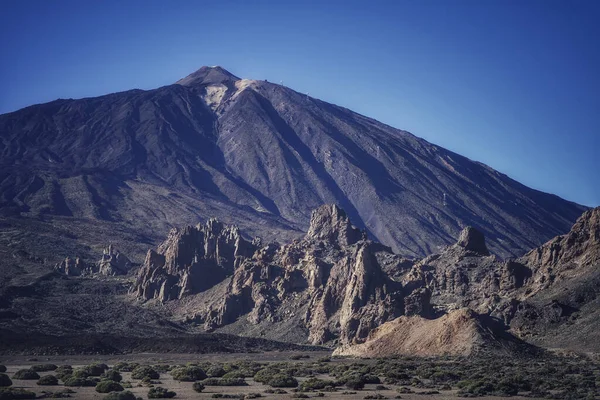 A beautiful view of a mountain under the clear blue sky