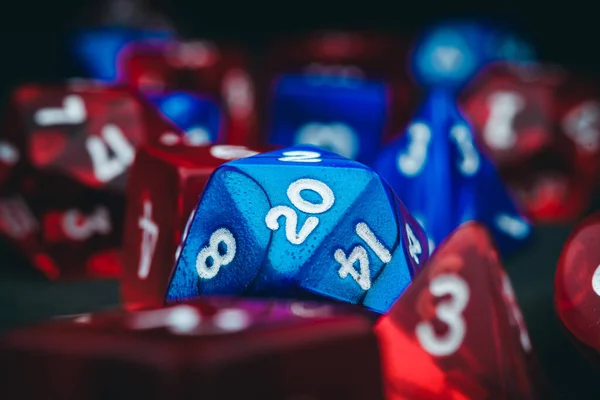 A closeup of blue and red dungeons and dragons dice