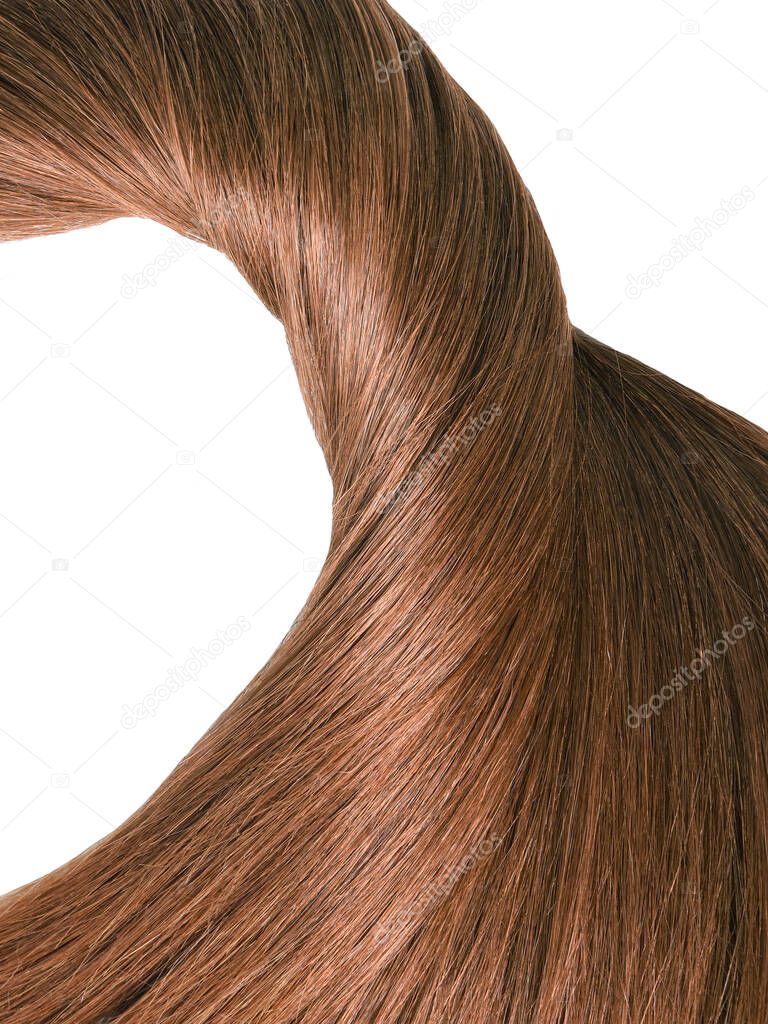 A strand of beautiful, soft and healthy brown hair isolated on a white background