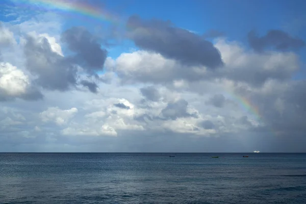 A beautiful rainbow in the cloudy sky over the ocean