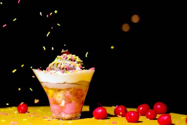 Süslemeleri ve sarı masasında böğürtlenleri olan güzel kek.