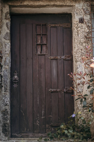 An exterior of a wooden front door