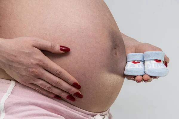 Closeup Pregnant Woman Holding Small Blue Shoes — Stock Photo, Image