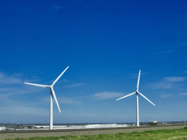 A couple of California windmills against a clear sky in the USA