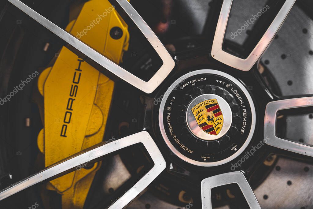 A close-up of a Porsche wheel with rim.