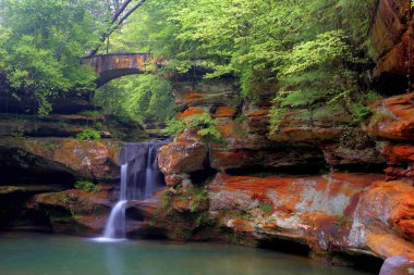 Amerika Birleşik Devletleri 'nin Ohio eyaletindeki Hocking Hills Eyalet Parkı' nda Yukarı Yaşlı Adam Mağarası Şelalesi 'nin uzun pozu.