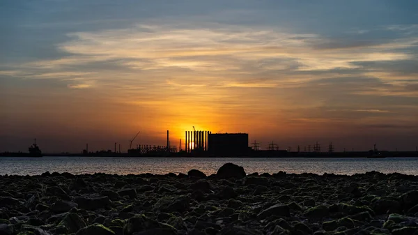 A scenic view of the sunset over the body of water in South Gare, Redcar, England.