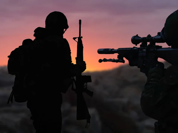 The silhouette of a military soldier with weapons at sunset