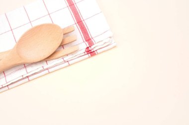 Ahşap kaşık ve çatal üst görünümü bej arka planda masa peçetesi ile metin için boşluk ile