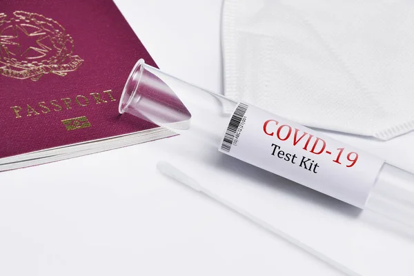 A closeup of a covid-19 test kit and travel passport isolated on white background