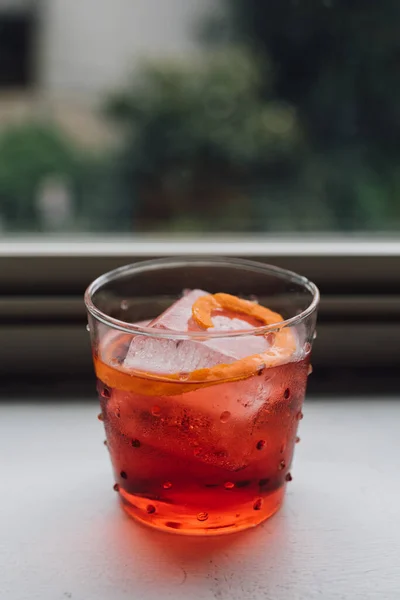 Electric Red Orange Negroni Cocktail Window Sill Lush Green Background — Stock Photo, Image