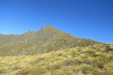 Dağ zirvesi mavi gökyüzüne karşı. Yeni Zelanda.