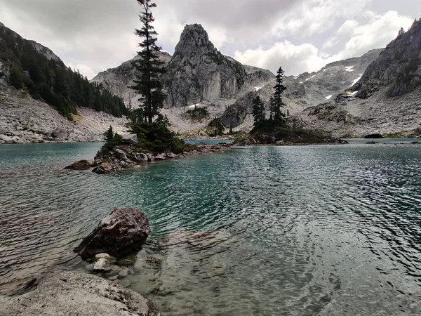 A beautiful shot of Water sprite Lake with rocky mountains under cloudy gray sky