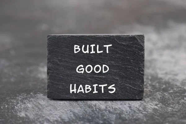 The words build good habits are standing on a blackboard, change lifestyle, healthy and positive attidude, motivation concept