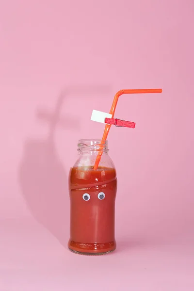 Bottle Tomato Juice Eyes Isolated Pink Background — Stock Photo, Image