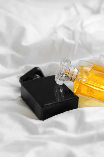 Tiro Vertical Duas Garrafas Perfume Lençol Branco Fundo Embaçado — Fotografia de Stock