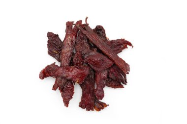 Beyaz arka planda kurutulmuş et parçalarının yakın plan çekimi.