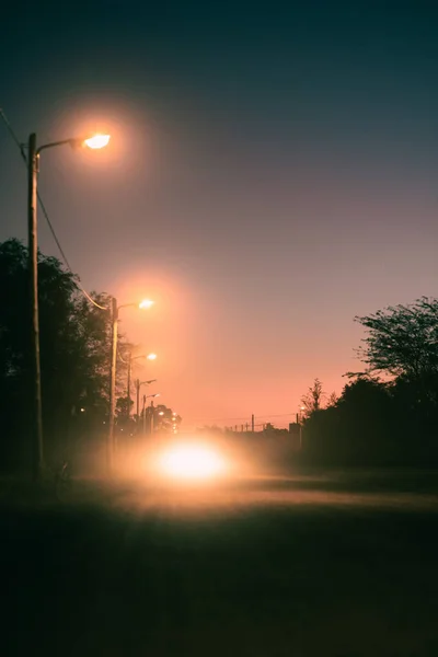 夜の路上で車のライトの垂直ショット — ストック写真