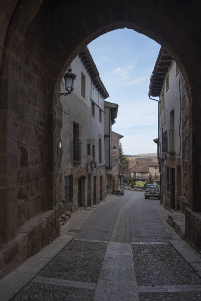 A vertical view of a narrow street and buildings in Guadalajara, Castilla-La Mancha, Spain