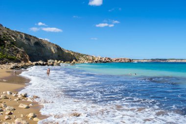 Güzel bir sonbahar gününde, Selmun, Mellieha, Malta yakınlarındaki Imgiebah Körfezi 'ndeki kumlu sahilde dalgalar ve mavi Akdeniz. Popüler banyo sitesi.
