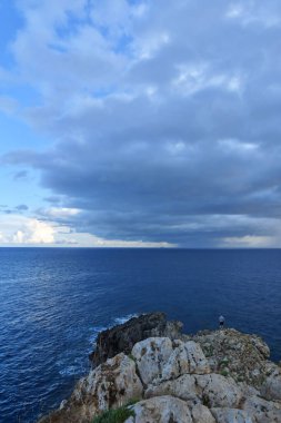 Stormy clouds over a sandy beach of Salento in Italy.