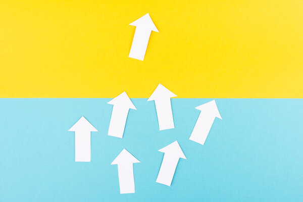 White arrows on a blue background, one is standing out, do different, be a winner, individuality, making your own decision, leadership, target