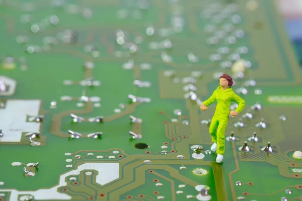 closeup of a female jogger on an electronic circuit board , concept: cycle of health