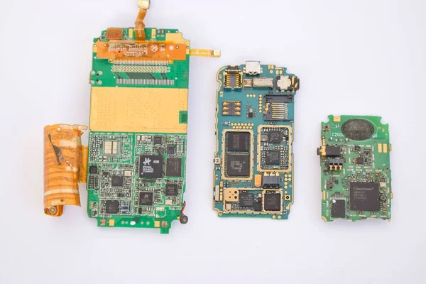 A closeup of a mobile phone mainboard components containing gold