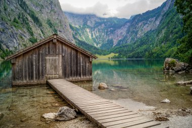 The wooden resort house on a mountain lake water, Schonau am Konigssee, Germany clipart