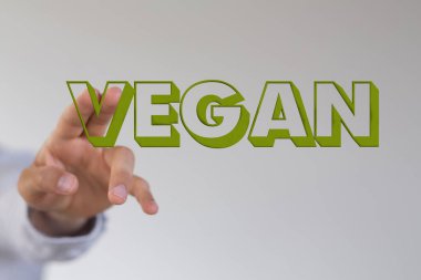 VEGAN metnini bulanık bir arkaplana işaret eden bir adam