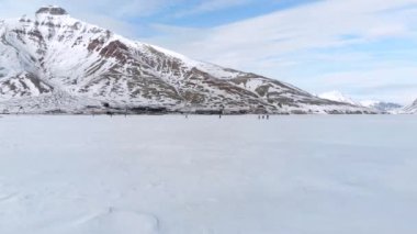 Spitsbergen 'de bulutlu gökyüzünün altında dağlarla kaplı güzel bir manzara.