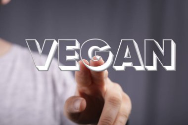 Bir sunumda Vegan 'ı gösteren bir kişinin eli. Organik üretim kavramı