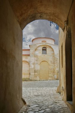 A narrow street among the old houses in the historic center of Otranto, a town in Puglia in Italy.