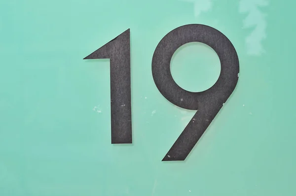 Closeup Shot Number Nineteen Sign Green Background — Stock Photo, Image